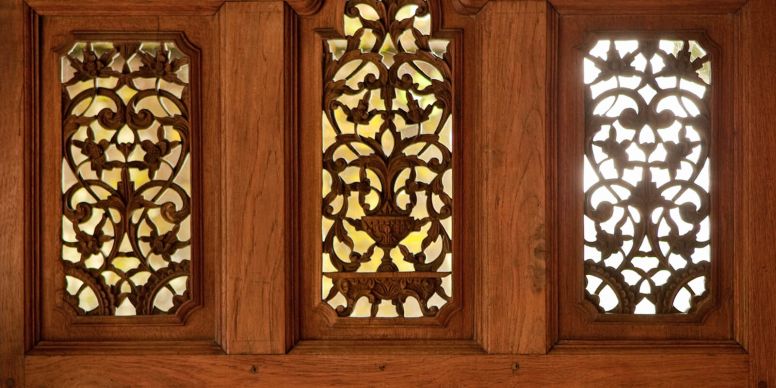 A Wood Paneled Wall With Stained Glass Windows