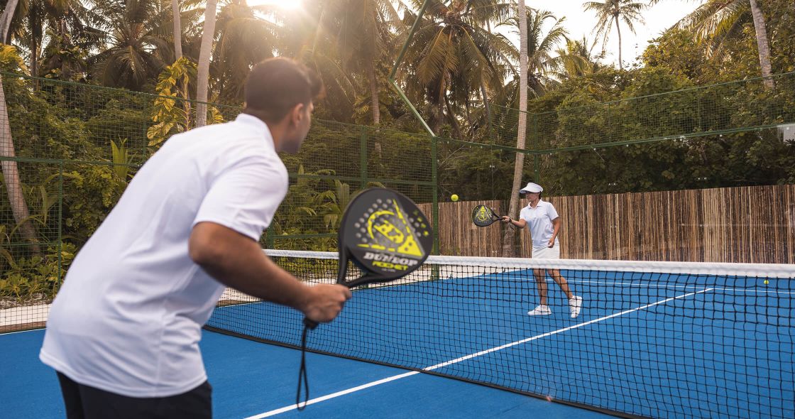 A Couple Of Men Playing Tennis
