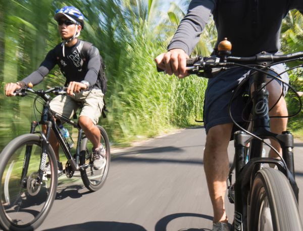 A Couple Of Men Riding Bikes