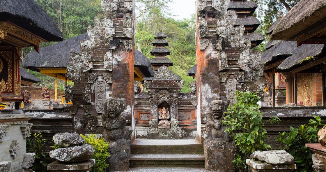 A Stone Building With A Statue In The Middle