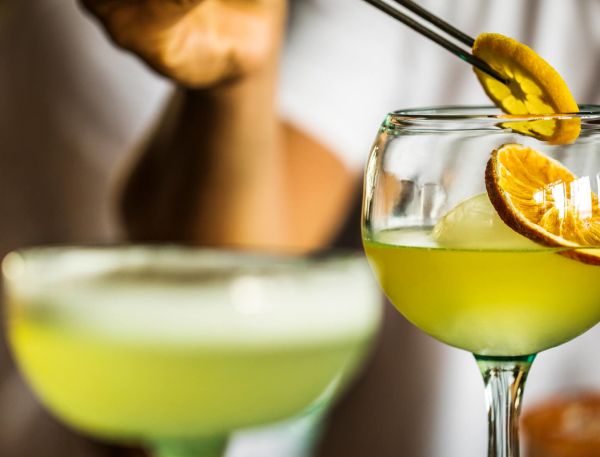 A Glass Of Liquid With A Lemon Slice On Top