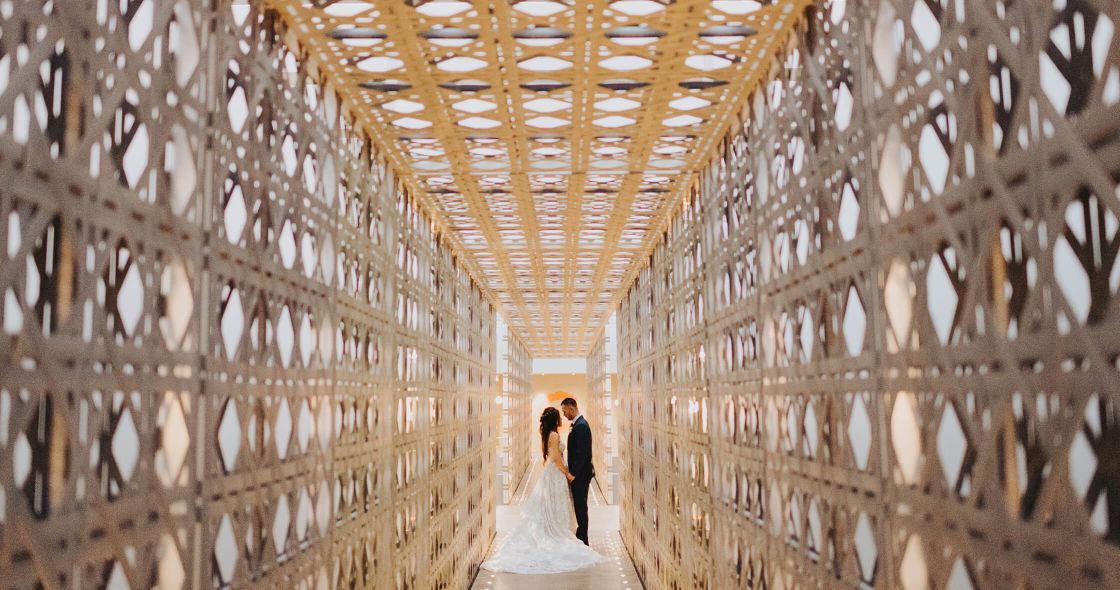 A Man And Woman In A Large Room With Many Rows Of Books