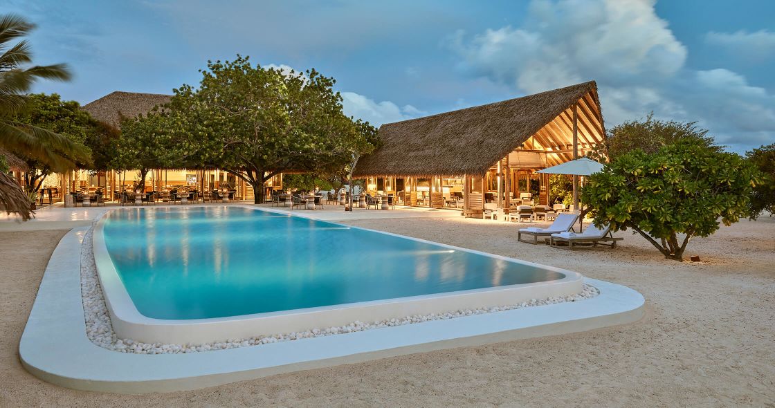 A Swimming Pool With A Building In The Background