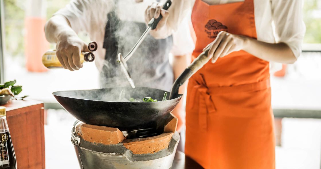 A Person Cooking Food In A Pot