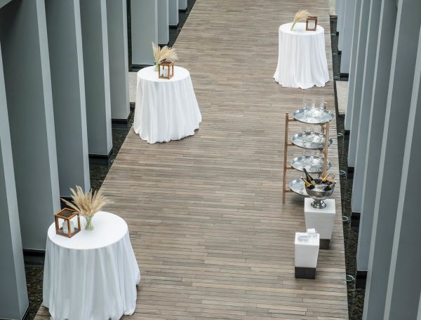 A Wooden Walkway With Tables And Chairs