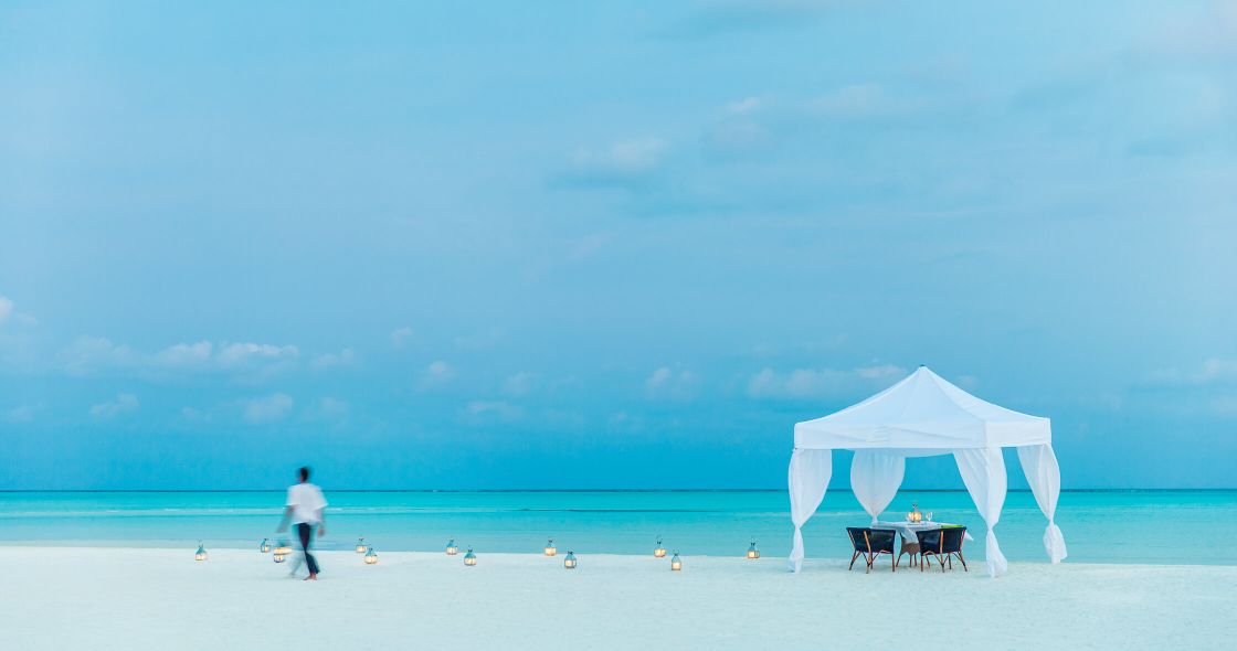 A Person Walking On A Beach