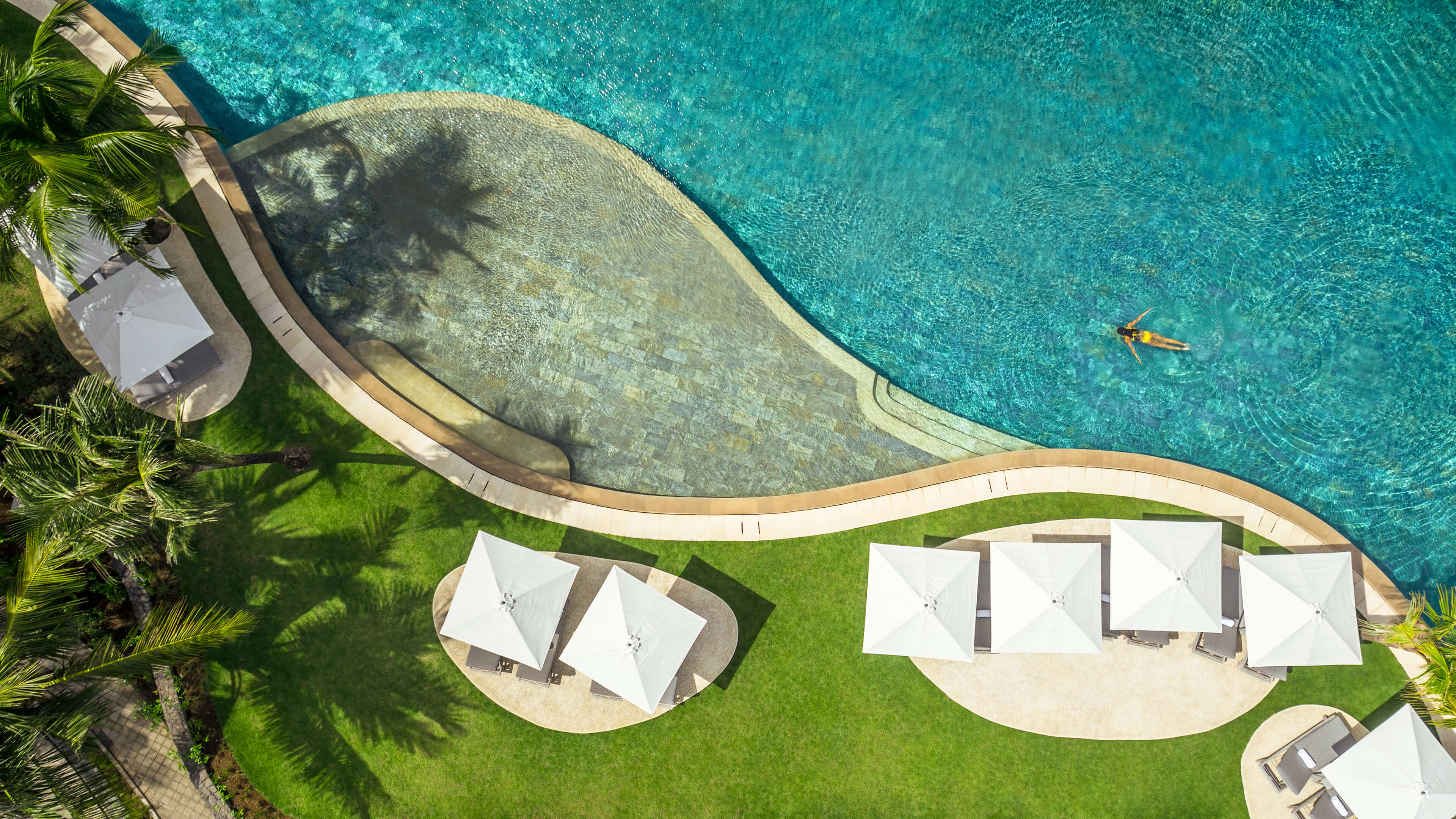 A Group Of White Tents On A Beach