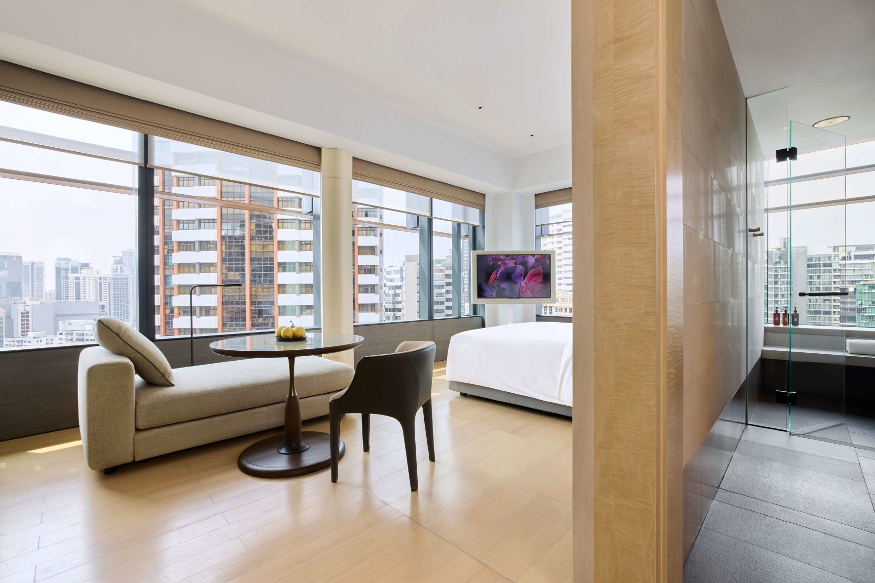 A Room With A Couch And A Table With A Tv In The Background