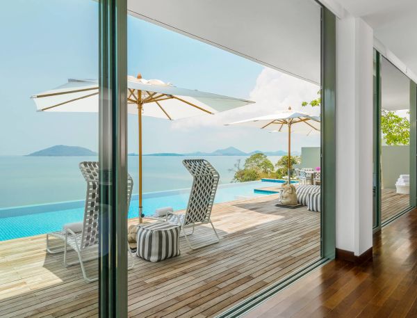 Infinity pool with outdoor deck and sun loungers