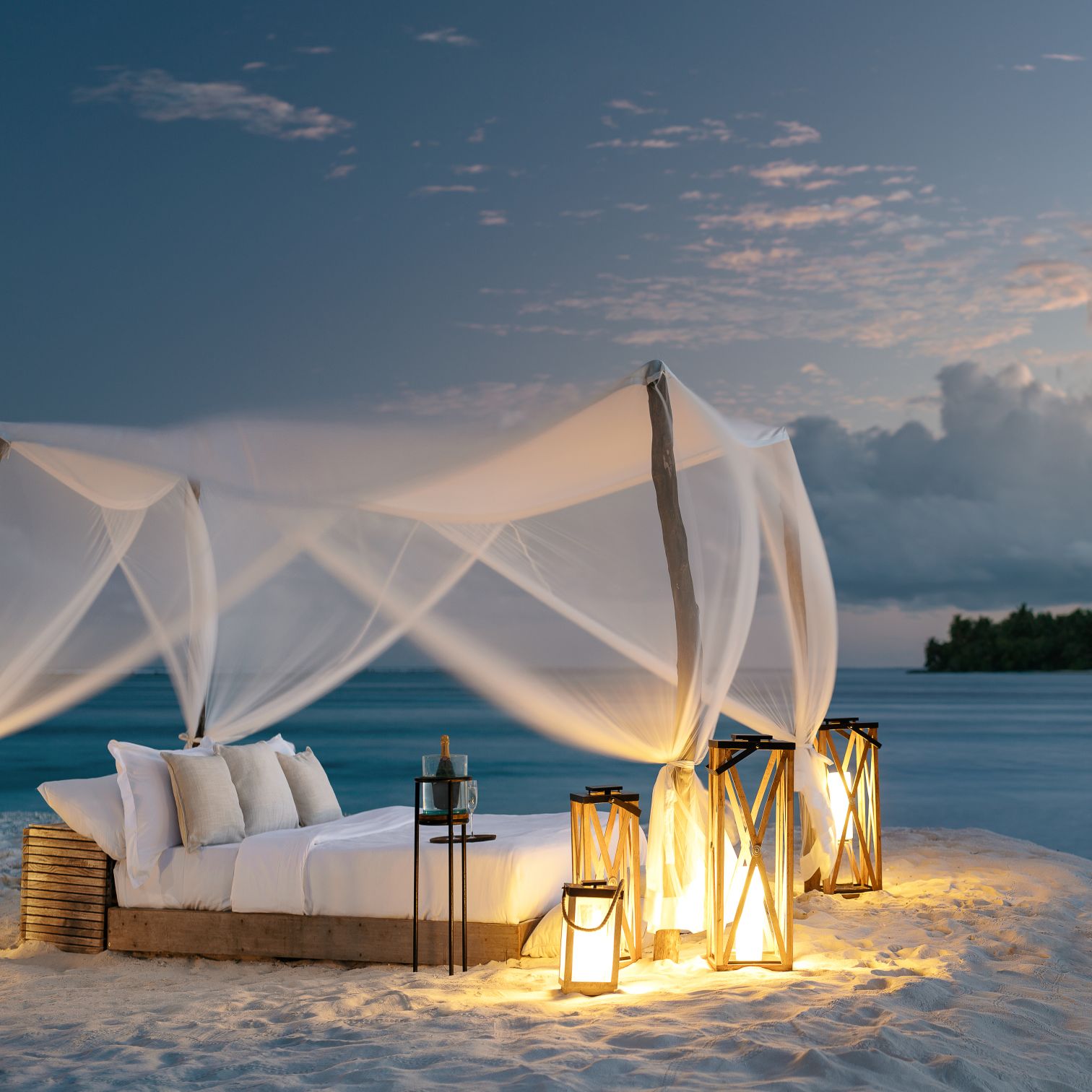 A Tent With Lights On A Beach