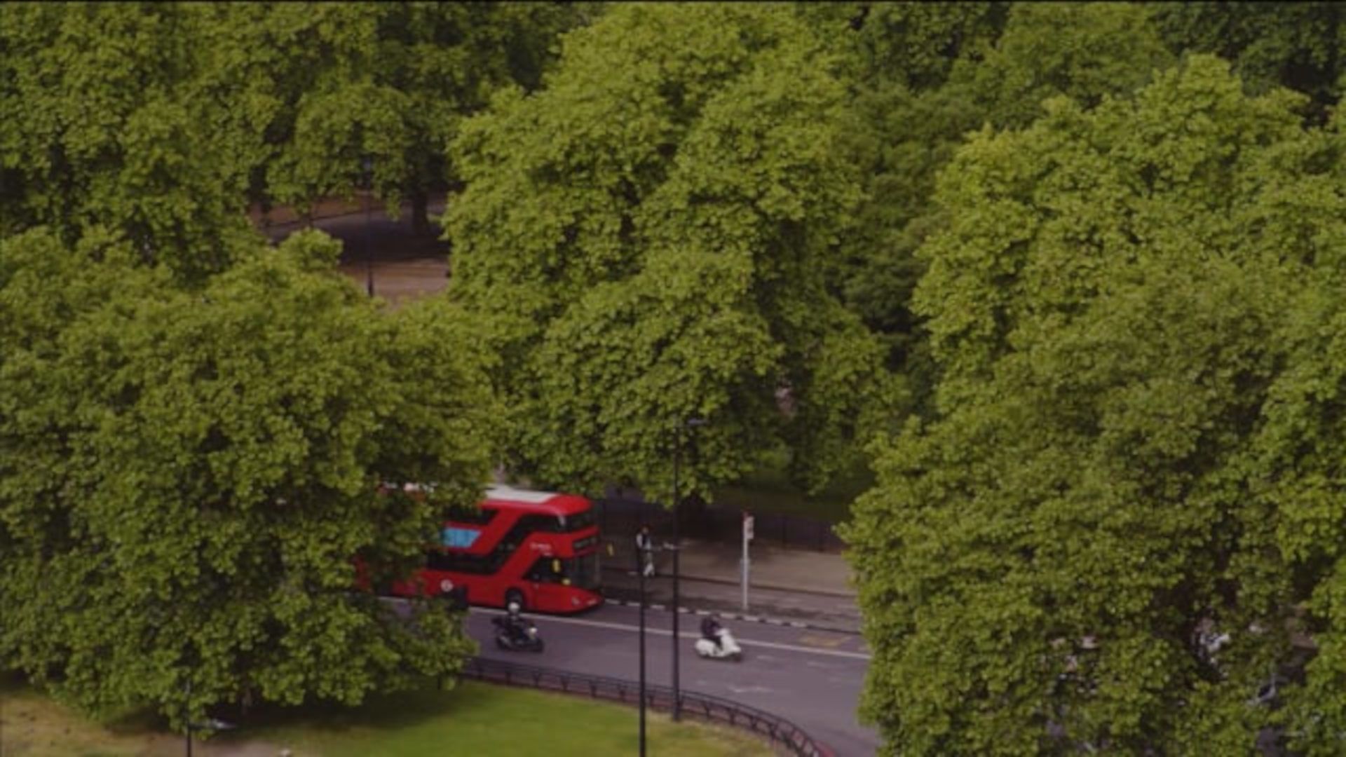 A Red Bus Driving Down A Road