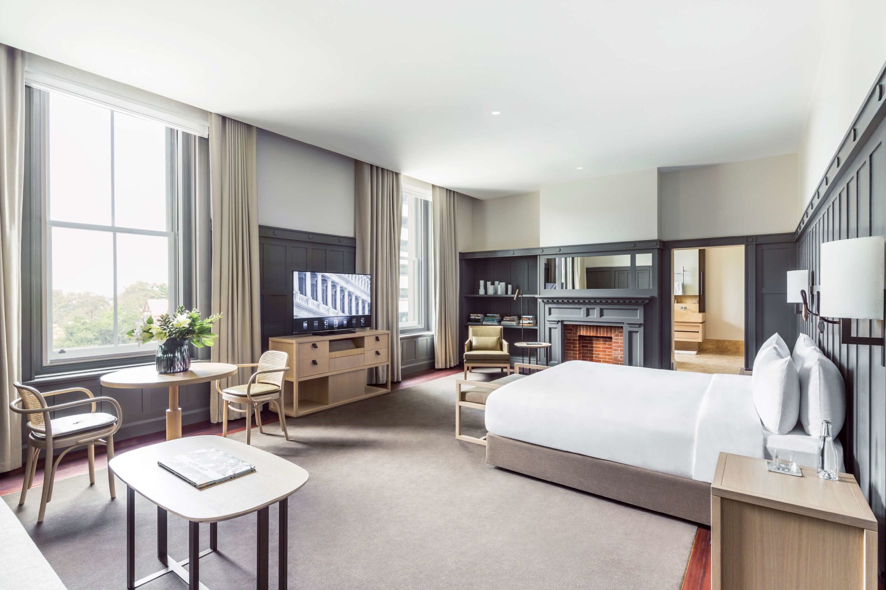 A Large Bedroom With A Fireplace