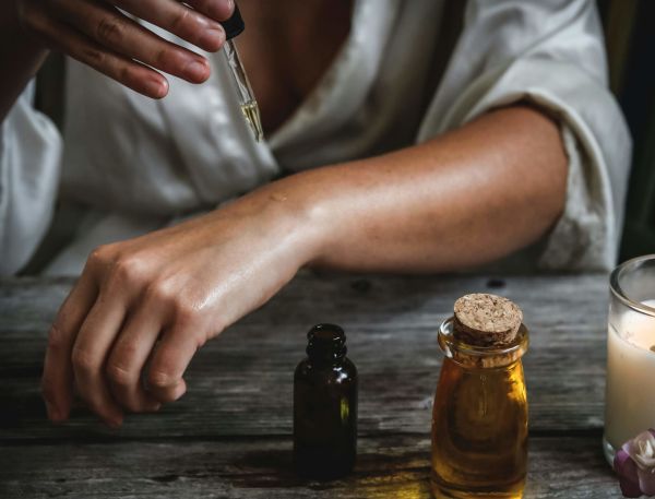 A Person Pouring Liquid Into A Glass