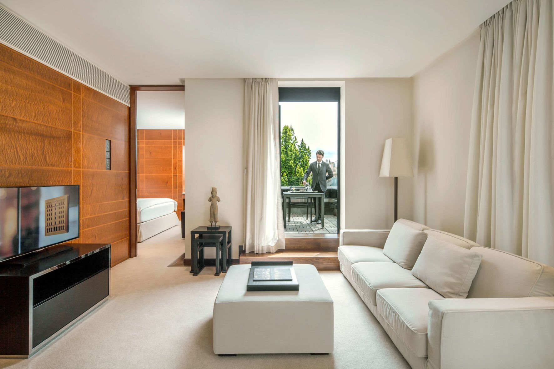 A Living Room With A White Couch And A White Table