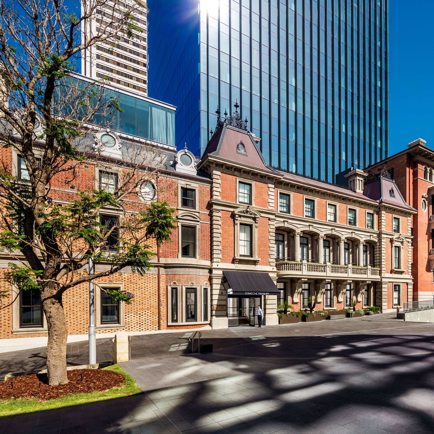 A Building With A Tree In Front