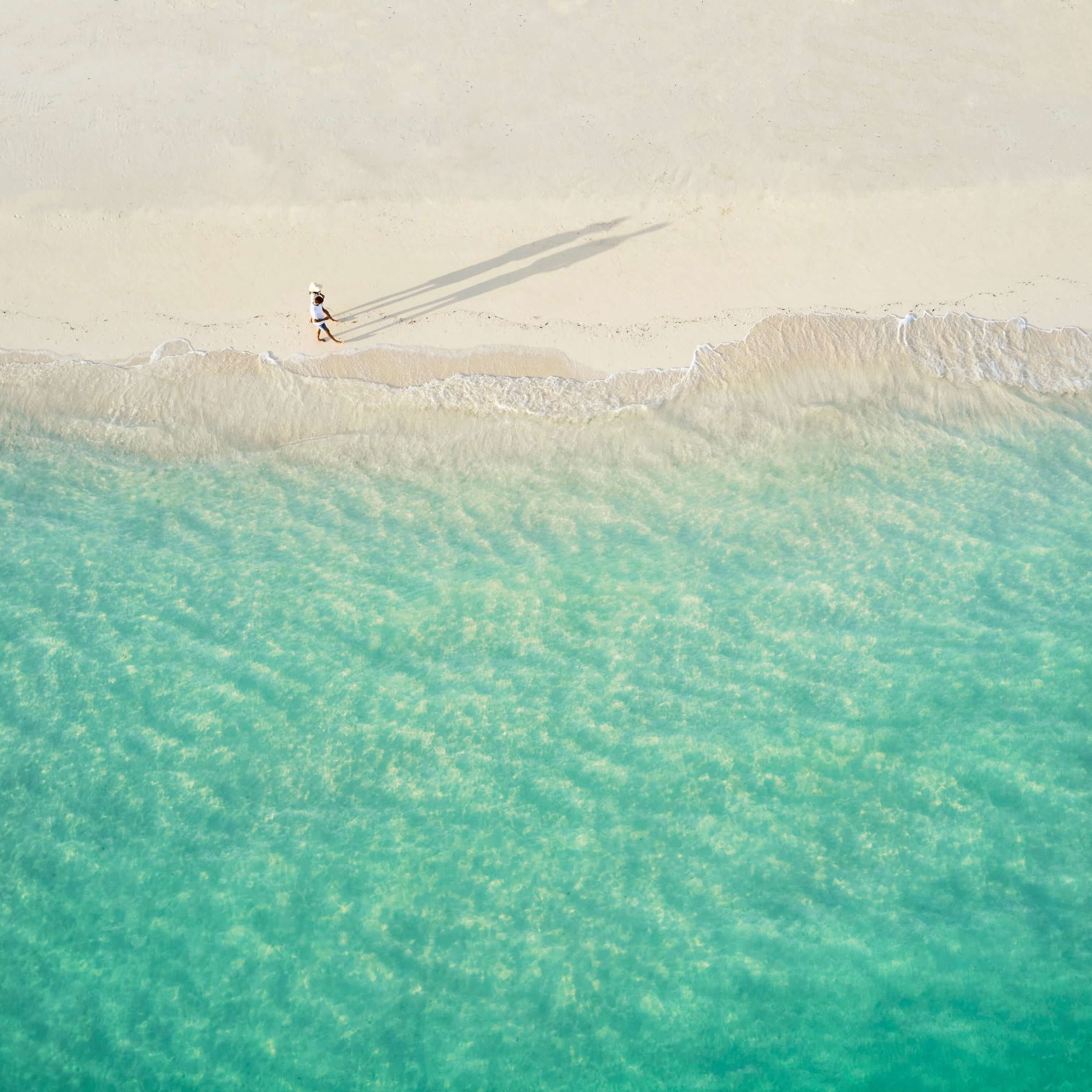 A Person Walking On A Beach