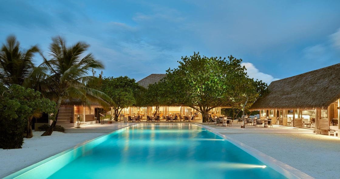 A Swimming Pool With Trees And Buildings Around It
