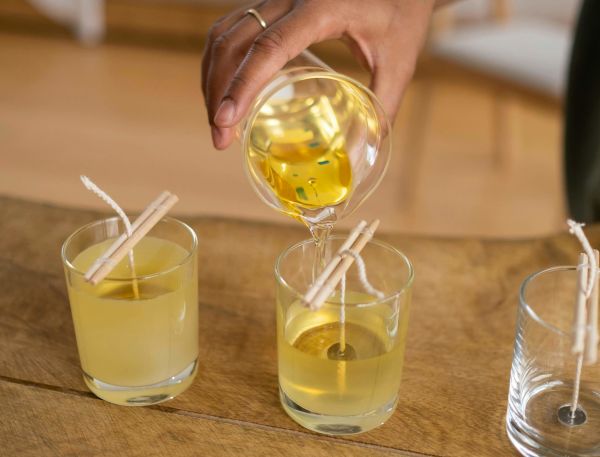 A Hand Holding A Glass Of Liquid