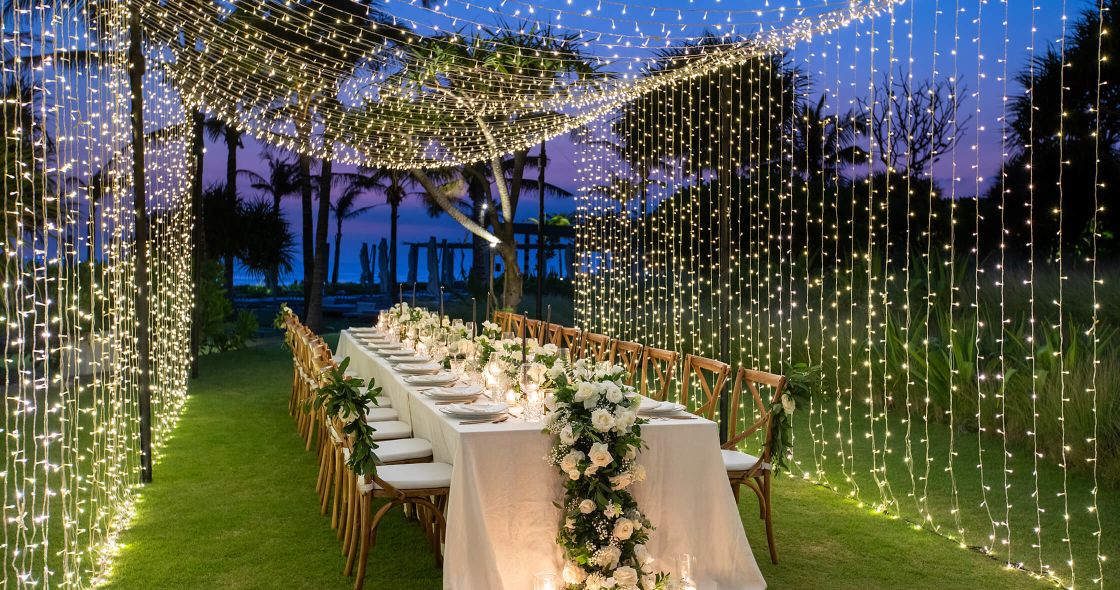 A Long Table Set With Flowers