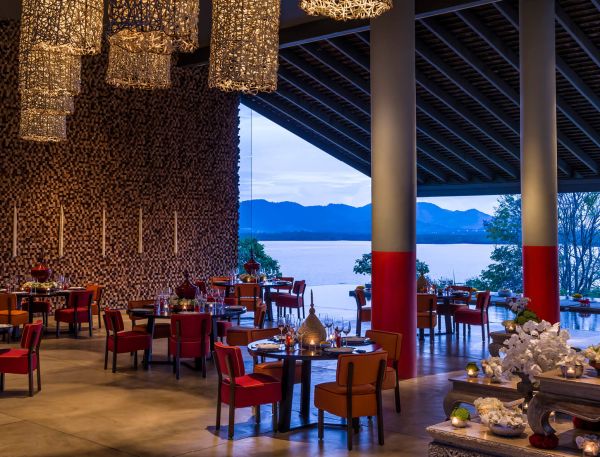 A Room With Tables And Chairs And A View Of The Water