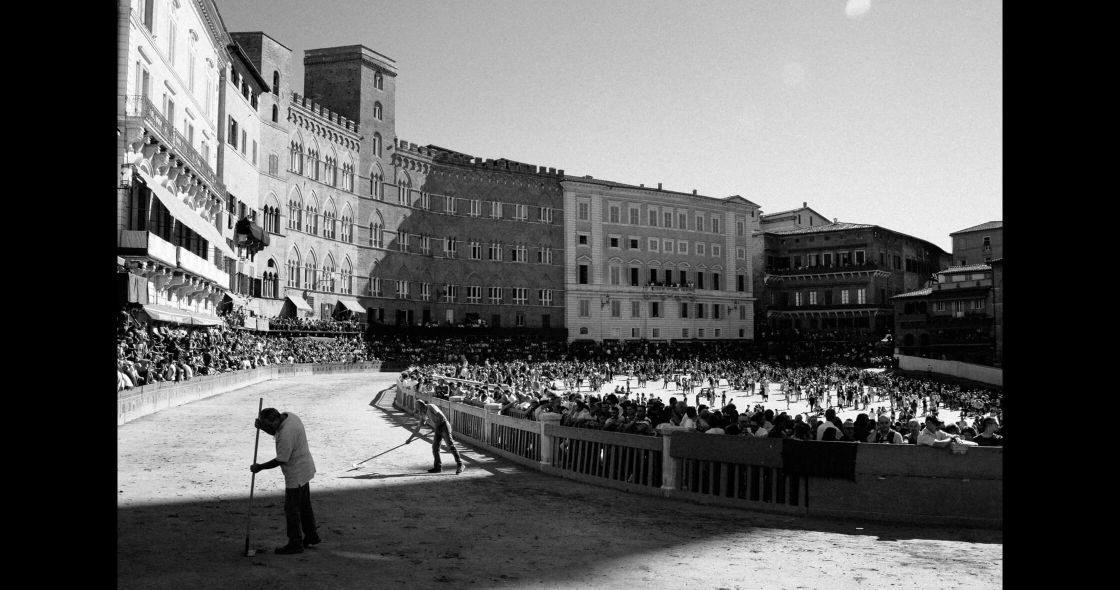 A Person Walking A Dog In A City
