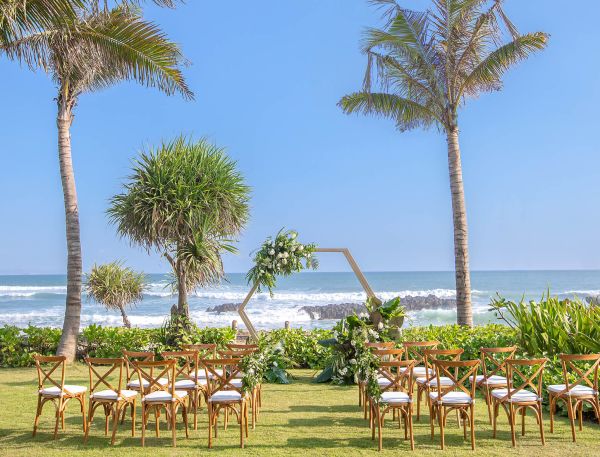 A Group Of Tables And Chairs Next To A Beach