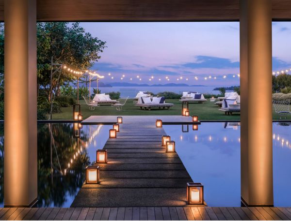 A Wooden Staircase Leading To A Body Of Water With Boats In The Background